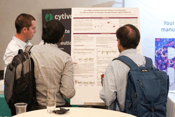 Attendees reviewing poster on SaRNA, Circular RNA and advanced RNA therapeutics research